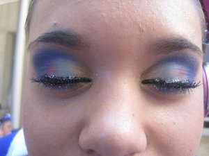 This is pretty old but one of my arts that i created on the cheerleader girls.  This make up is by urban decay using the gold, green, pink, and purplish blue with drug stores glitter eyeliner. 