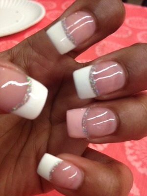 French tips with the ring finger a light pink. As well as a glitter line underneath.