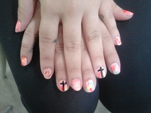 Watercolor mani with mostly pastels, and crosses on accent nails.