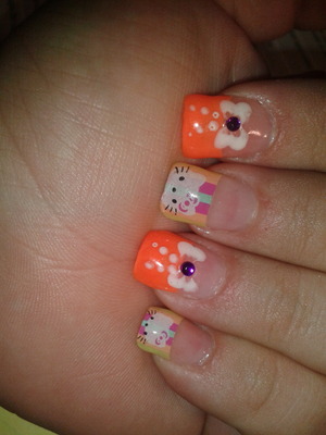 hello kitty tips with neon orange on every other.... white bows with purple rhinestone.