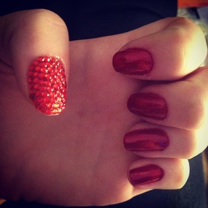 red gems on finger nail and red orly nail polish ready for Christmas! 

