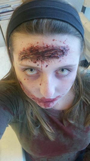 Gory zombie look with prosthetic wounds and costume contact lenses. For more information please see my MakeupBee profile.