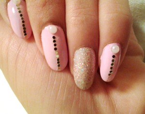 Accent nail in sparkles.
Rest of hand in pink with n accent pearl and a line of individual glitter.