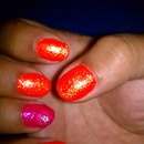 Glittery Neon Orange Mani with Pink Flower Accent Nail