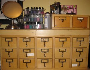 I store my makeup in two old card catalog cabinets.