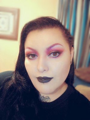 Very intense pink and rose gold eye,  dark pink brows, and black lips. 