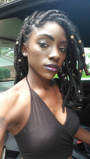 A simple almost smokey eye and a bold purple lip. I used black opal foundation and LA girl concealer and iman lipstick in "taboo" the eyes are from a h&m pallet.