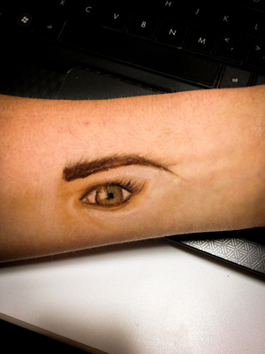 Eyeball art done on wrist using greasepaint.