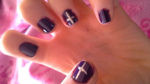 Purple nails with the art of a silber cross, they arnt the best though! <3