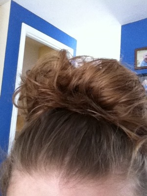 Its a messy rainbow bun. I always get lots of compliments on. Its fun, easy and saves time.  First i put my gel and moose in. Next i scrunch my hair throw it up in a messy pony tail. Then i fold my ponytail over and spread it out. After that i tied the extra hair with bobby pins amd tucked the hairs in. Spray hairspray and bam you're done. Its super easy and very fun. 