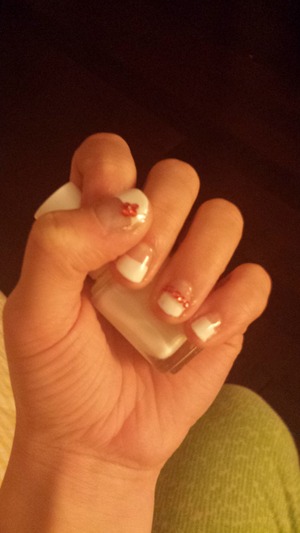 Half nude, half white nails with pretty red gems on accent nail and thumb!
