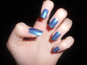 Nicole by O.P.I.'s "It's Up to You" under one coat of China Glaze's "Fairy Dust". 
A lot of people have told me that these look like space. C:
