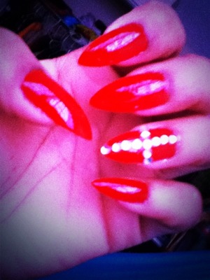 BRIGHT RED NAILS WITH A DIAMOND CROSS DESIGN 