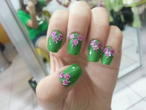 Pink clovers over army-green polish