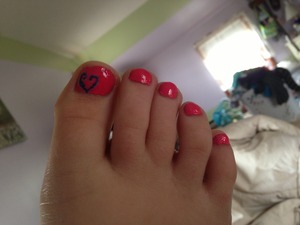 Coral Painted nails with a little blue heart