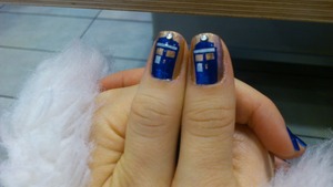 My sister painted her nails to look like the T.A.R.D.I.S. from Doctor Who and finished it with a nail jewel for the light at the top.