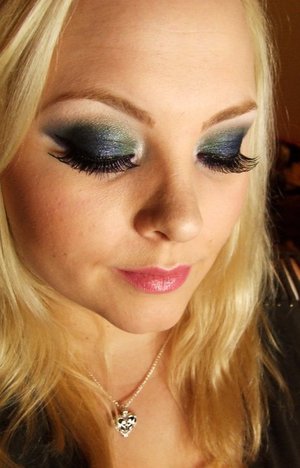 Smokey Peacock eyes and a subtle hue of pink on the lips & cheeks.