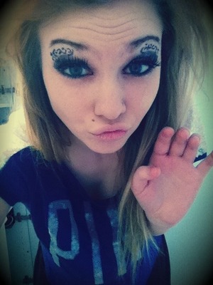Eyeliner for the cheeta a over my eye and purple eye shadow and glitter for the rest also that's a fake mole I drew :) 
