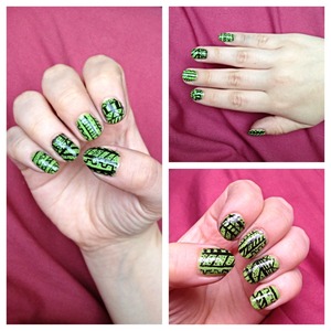 Green nails with a black tribal/Aztec design. 