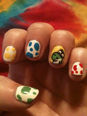 Yoshi Nails.  I found a YT tutorial for it and took a stab at recreating it.  I messed up his throat, but my friend gave me the good idea that Yoshi looks like he just swallowed a shell and that's why his throat is bulgy.