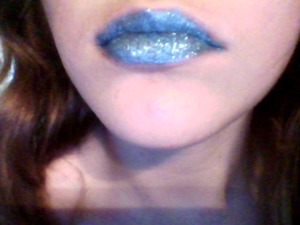 I used a basic sticky lip gloss and used my finger to pat on blue MAC gliter 