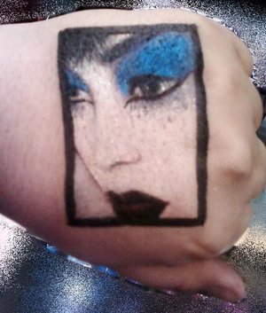 A picture of an actual photo displayed at a makeup booth, on my hand in all eye shadow and makeup medium