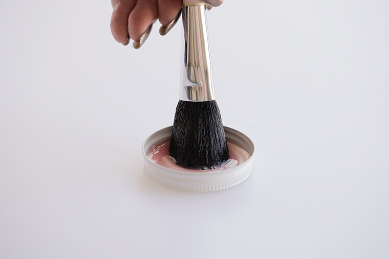Dip the tip of the powder brush