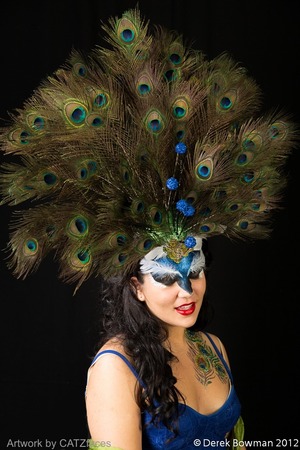 I made a head piece out of styrofoam, headband, feathers and pipecleaners to showcase some glitter makeup.  I used LIT Cosmetics glitter with a pros-aide adhesive for the feathers on her chest.  Liquid latex with the glitter and eyebrow feathers on her forehead. 