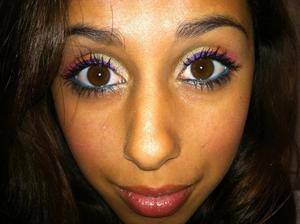 A way to do the "rainbow eyes". All colors are in the sephora mini shopping bag, start with green the to orange, finish with the pink, teal for the water line, and a purple eye liquid liner, finish with coats of black mascara. Dust pink on the cheeks. Shimmer on the lips. 