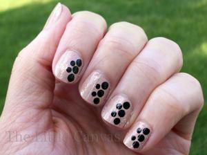 Nude polish with some Essie Shine of the Times and black dots