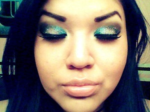 Smokey eye with with a teal liner and 3D glitter 