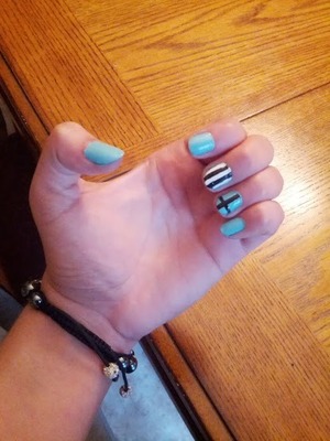 Mint nail polish, black and white stripes with a cross