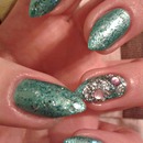 Green manicure with glitter