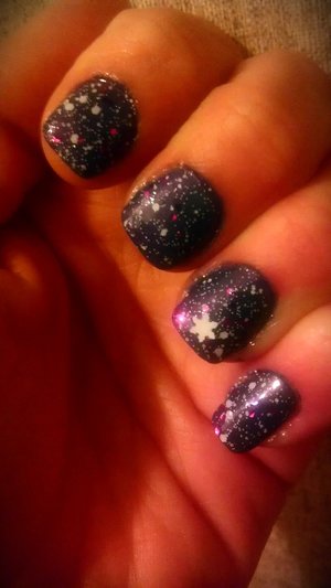 A pale dark blue mani with a purple pink and white glitter, And to top it all off...a beautiful snowflake on the ring finger to give it a real wintery look <3
