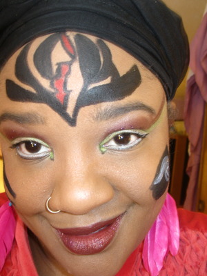 A FB friend of mine said that the tribal beauty look reminded her of the program tribe. "Ebony".. is the name of the Character she resonates with. So, I googled "Ebony" and copied this symbol that is on her forehead.  The brush strokes are too wide but Santa is visiting me this year and I know I am getting some better brushes for precision!!