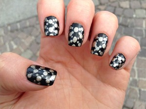 base coat, golden metallic dots on black nail polish with top coat