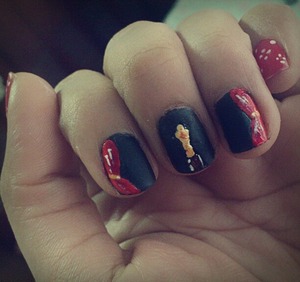 Nail newbie here. A bit messy, but here's my ode to the Academy Awards: red curtains and the golden statue in the middle.