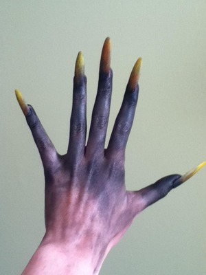 sharpened fake nails glued on and painted with acrylic paint