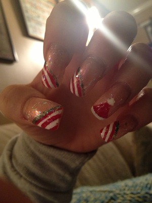 Holiday nails with a Santa hat on the ring fingers 
