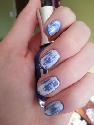 This nail design gives you the look of acid washed jeans right on your hand! First paint the nails a dark blue (I like to use 2 coats). Let this dry then paint on a coat of white. When the white is dry take a qtip or paper towel (I like to use an old makeup removing wipe) and gently rub off parts of the white until you reach your desired look.