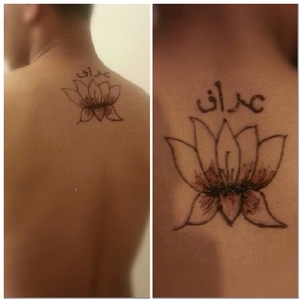 henna on a males back with name in arabic 