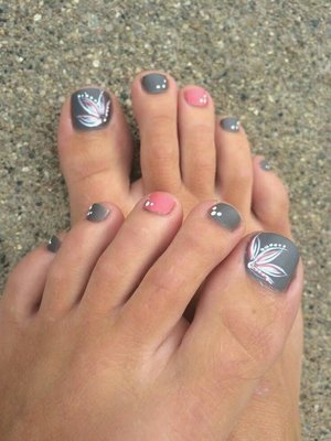My toes twinkling with matte gray base polish and designs in white on all but the middle (3rd) toes, which are painted with glossy pink polish with white dots.