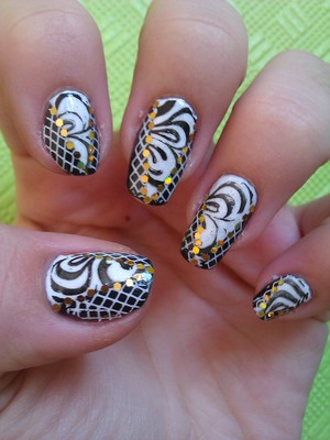 This is a verry cool, interesting and very stylish look. It's black and white, so you can wear any colour with it. I added the golden flat rhinestones to hide the harsh lines. It's really nice! Check my blog for more info: http://nailartbylynn.tumblr.com/