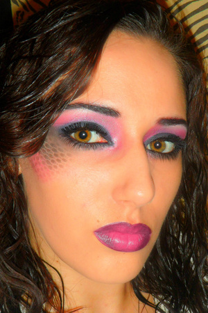Black, pink and purple on the lib. Black and pink pattern on cheek bone with purple and black lips.