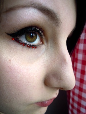 Basic cat eye with a liquid eye liner, some red rhinestones, and some individual lashes
