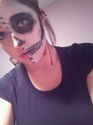 half zombie face done with primer, facepaint, eyeshadow and fake blood!