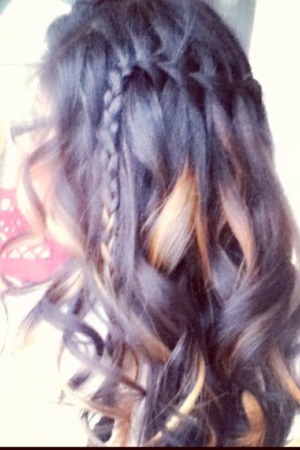 Water fall braid that ends off to the side. The rest of the hair is curled.
