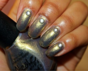 This picture really doesn't do this polish any justice... It's such a unique color. Nicole By Opi Sea How Far You Go is a gray-gold shimmer with glass flecks. For some odd reason, it looks a bit patchy in this photo. It's a really nice color! This was two coats. Rhinestones are by Bundle Monster.