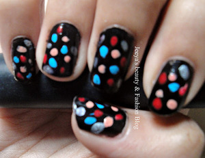 I have created this nail art using a tooth pick and four random nail polishes over a black base color. An easy way to jazz up your favorite black nail color this winter...for more details visit :http://de-jeeya.blogspot.com/2011/12/notd-dotty-dots-nail-ar