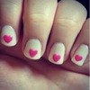 Nude nails with pink hearts.